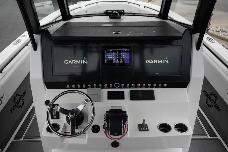 Slide: The Image of 2023 Fountain Bluewater 38 Tournament Edition boat dashboard with Garmin navigation displays. - 23