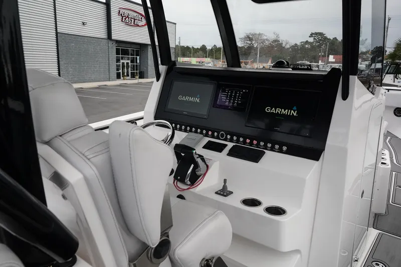Slide: The Image of 2023 Fountain Bluewater 38 Tournament Edition boat cockpit with Garmin navigation displays. - 24