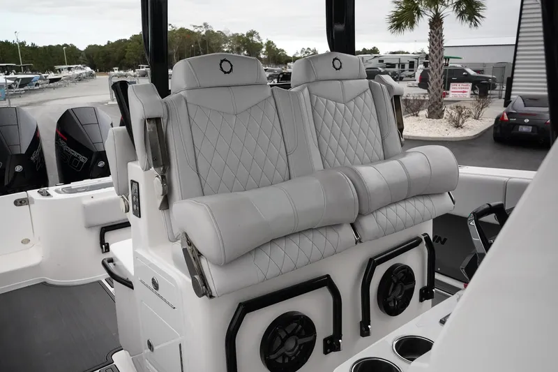 Slide: The Image of 2023 Fountain Bluewater 38 Tournament Edition boat seats with quilted design and cup holders. - 31