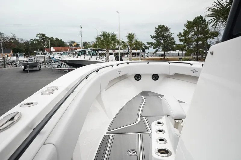 Slide: The Image of 2023 Fountain Bluewater 38 Tournament Edition boat, sleek design, docked outdoors. - 33