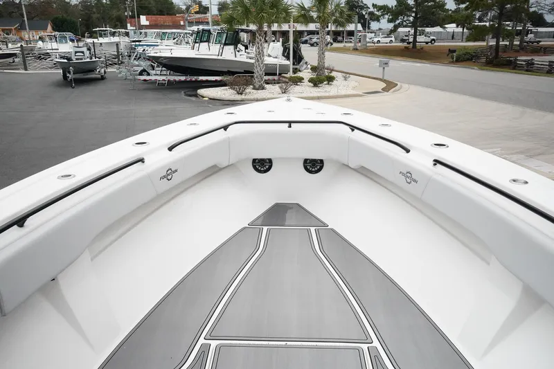 Slide: The Image of 2023 Fountain Bluewater 38 Tournament Edition boat, spacious deck, sleek design, marina background. - 34