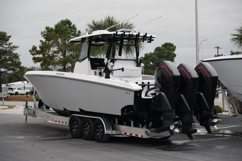 Slide: The Image of 2023 Fountain Bluewater 38 Tournament Edition boat on trailer with triple engines. - 4