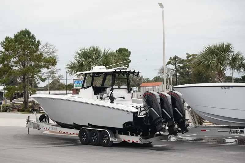 Slide: The Image of 2023 Fountain Bluewater 38 Tournament Edition boat on trailer with multiple outboard engines. - 8
