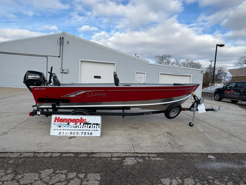 The Image of 2025 Lund 1600 Fury Tiller boat on trailer, displayed at Hennepin Marine dealership. - 0