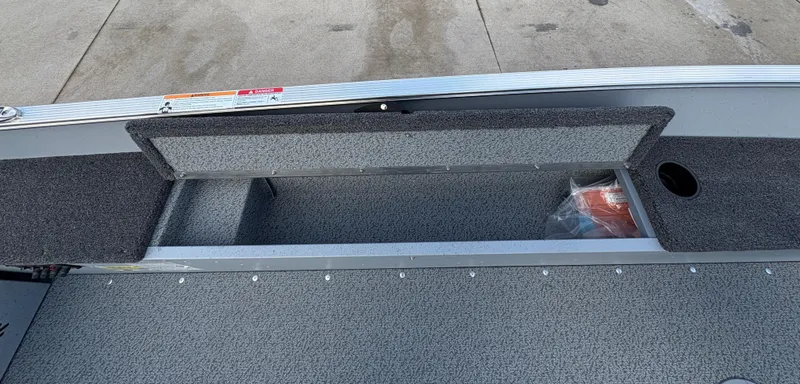 Slide: The Image of 2025 Lund 1600 Fury Tiller boat interior storage compartment, open and empty. - 16