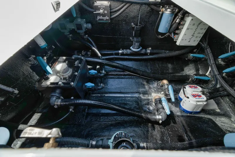 Slide: The Image of Engine compartment of 2025 Yellowfin 36 Offshore boat, showcasing mechanical components and wiring. - 14