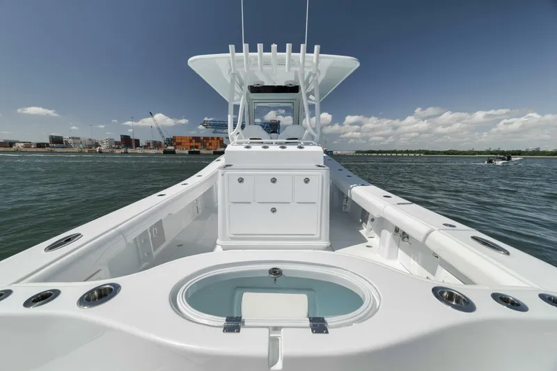 Slide: The Image of 2025 Yellowfin 36 Offshore boat on water, showcasing spacious deck and sleek design. - 18