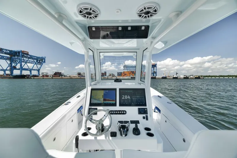 Slide: The Image of 2025 Yellowfin 36 Offshore boat dashboard with modern controls on open water. - 23