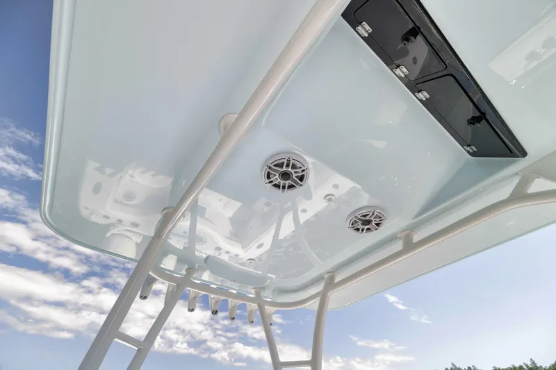 Slide: The Image of 2025 Yellowfin 36 Offshore boat canopy with speakers and rod holders against blue sky. - 26
