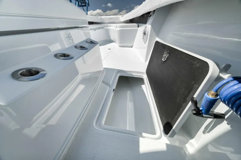 Slide: The Image of 2025 Yellowfin 36 Offshore boat interior with rod holders and storage compartment. - 30