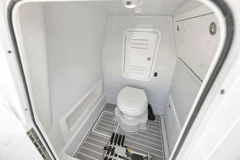 Slide: The Image of 2025 Yellowfin 36 Offshore boat interior bathroom with modern design and compact toilet. - 37