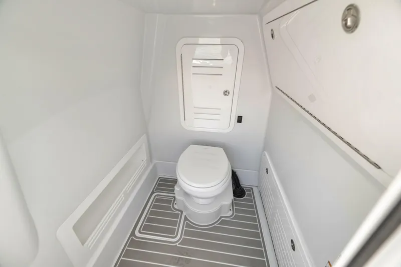 Slide: The Image of 2025 Yellowfin 36 Offshore boat interior bathroom with modern design and compact toilet. - 39