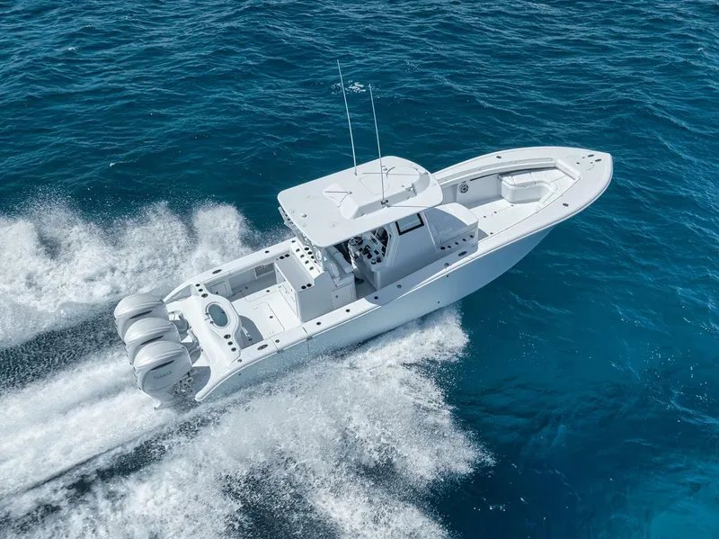 Slide: The Image of 2025 Yellowfin 36 Offshore boat cruising on clear blue ocean waters. - 41