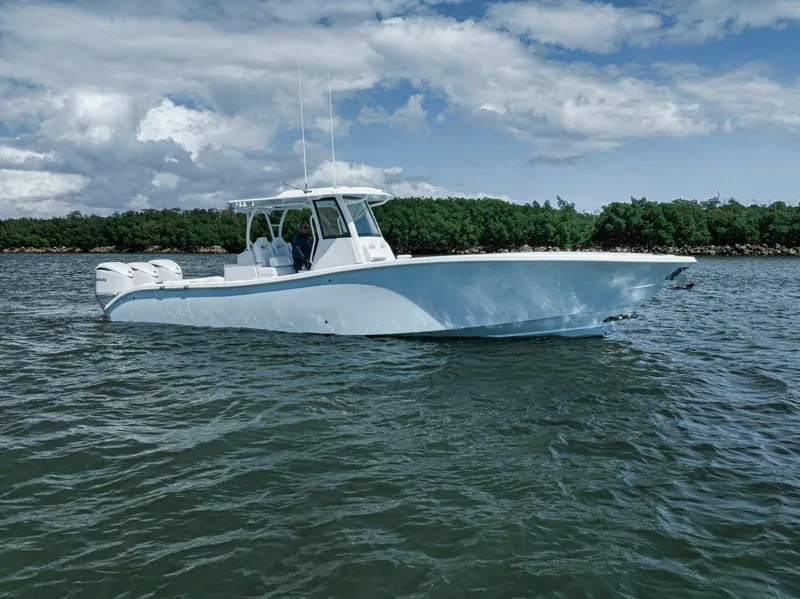Slide: The Image of 2025 Yellowfin 36 Offshore boat on water, under cloudy sky. - 43