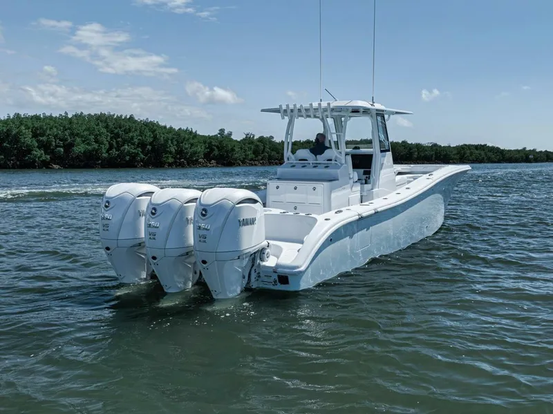 Slide: The Image of 2025 Yellowfin 36 Offshore boat with triple Yamaha engines on calm water. - 44