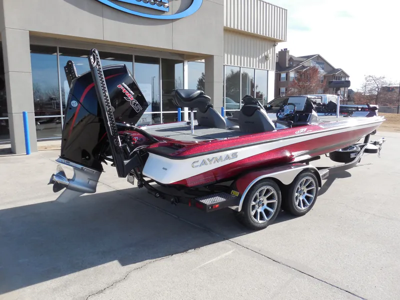 Slide: The Image of 2025 Caymas CX21Pro boat with trailer, parked outside a building. - 3