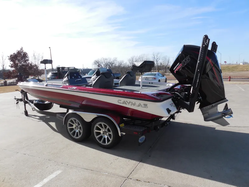 Slide: The Image of 2025 Caymas CX21Pro boat on trailer, red and white, parked outdoors. - 4