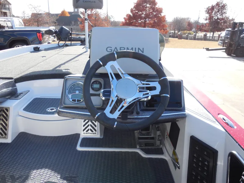 Slide: The Image of 2025 Caymas CX21Pro boat dashboard with Garmin navigation system and steering wheel. - 7