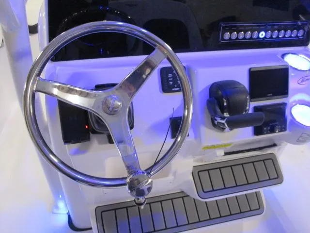 Slide: The Image of Steering console of 2025 Tidewater 220 LXF boat with illuminated controls. - 12