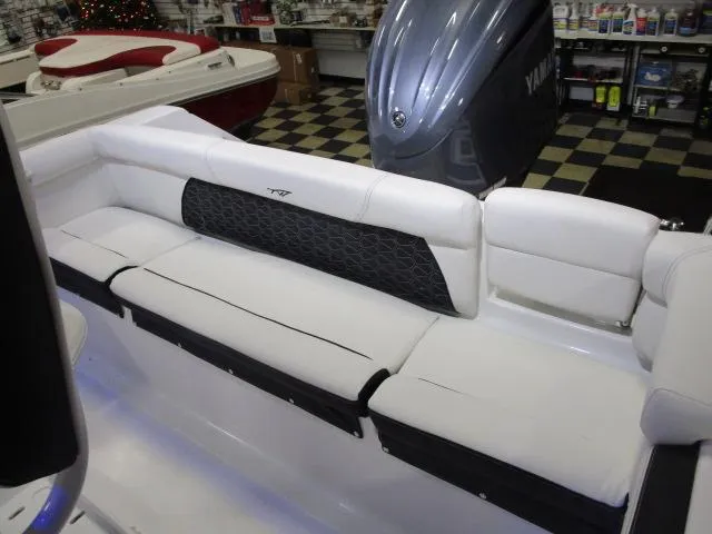Slide: The Image of 2025 Tidewater 220 LXF boat interior with white seating and Yamaha engine. - 14