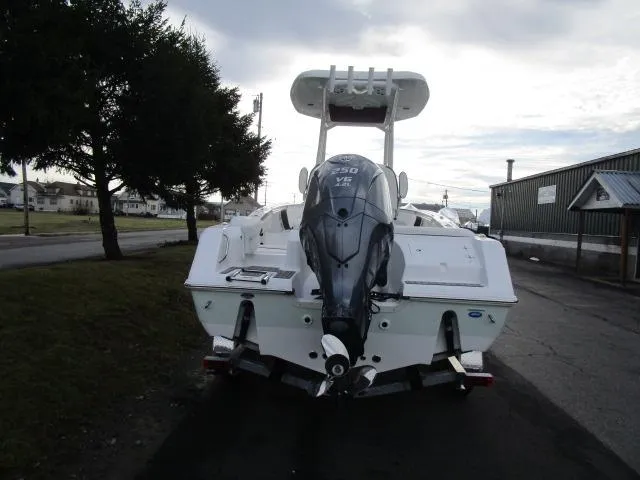 Slide: The Image of 2025 Tidewater 220 LXF boat with powerful outboard motor, parked on a paved area. - 24