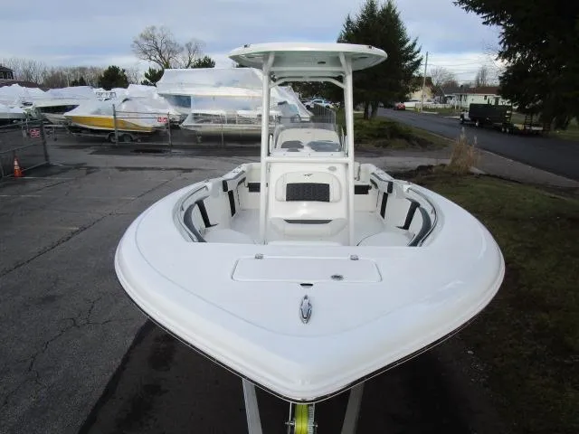 Slide: The Image of 2025 Tidewater 220 LXF boat, white exterior, parked outdoors on a cloudy day. - 25