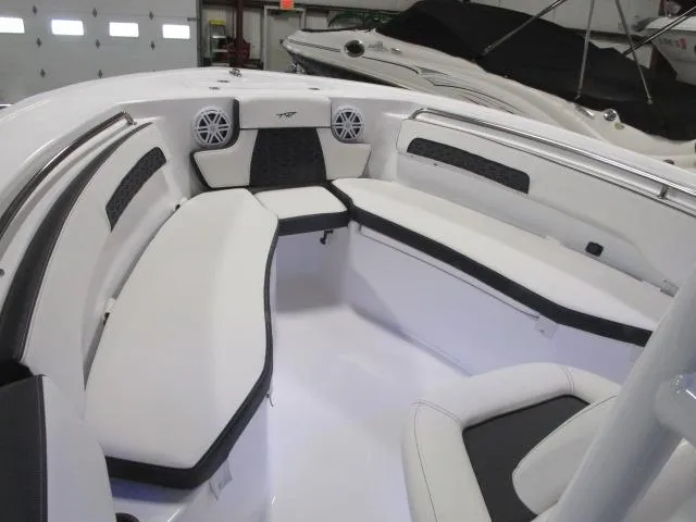 Slide: The Image of 2025 Tidewater 220 LXF boat interior with white seating and speakers. - 6