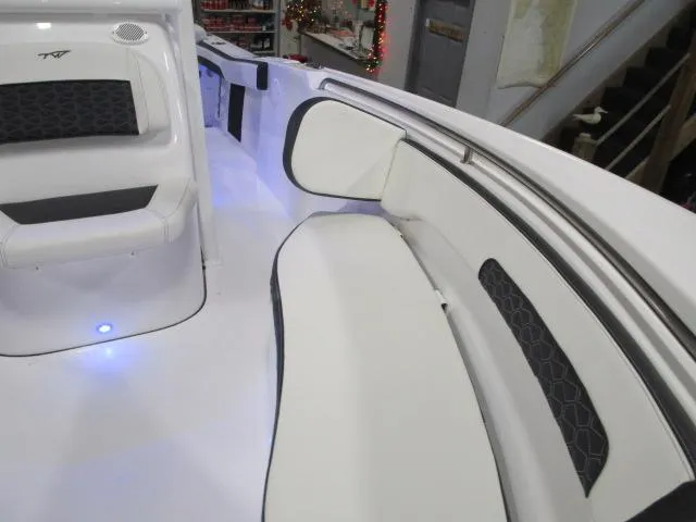 Slide: The Image of 2025 Tidewater 220 LXF boat interior with white seating and blue LED lighting. - 8