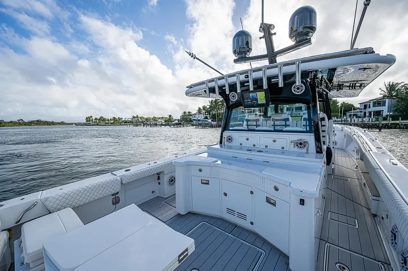 Slide: The Image of 2023 HCB 53 Sueños boat, spacious deck, luxury design, on calm waters. - 12