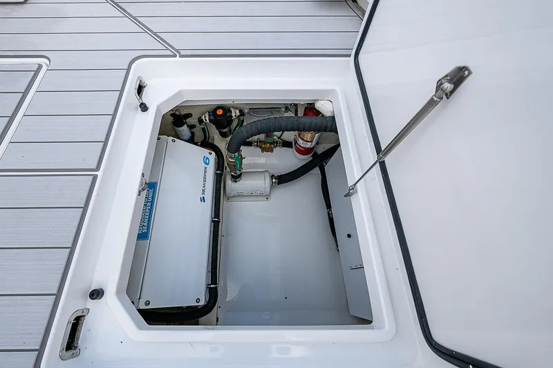Slide: The Image of Open hatch of 2023 HCB 53 Sueños boat showing internal equipment. - 13
