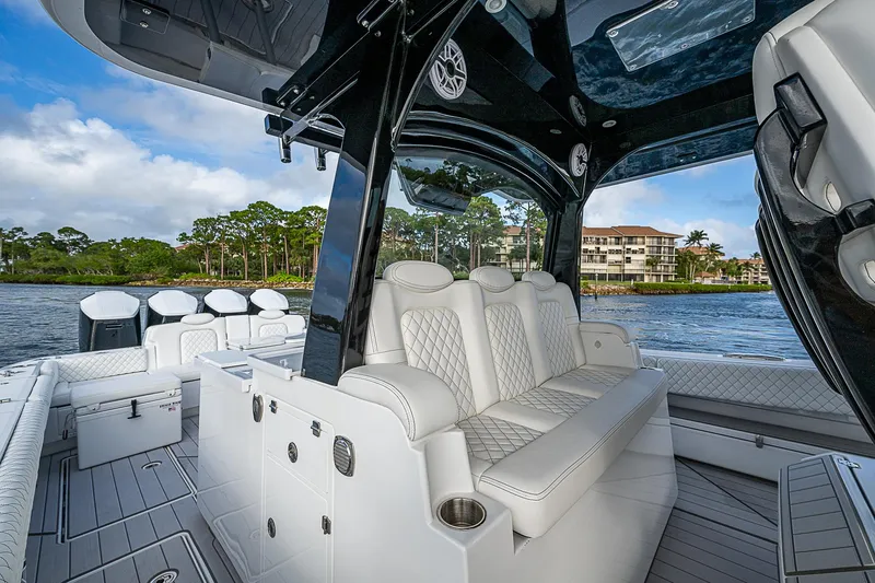 Slide: The Image of Luxurious 2023 HCB 53 Sueños boat interior with plush seating and scenic waterfront view. - 16