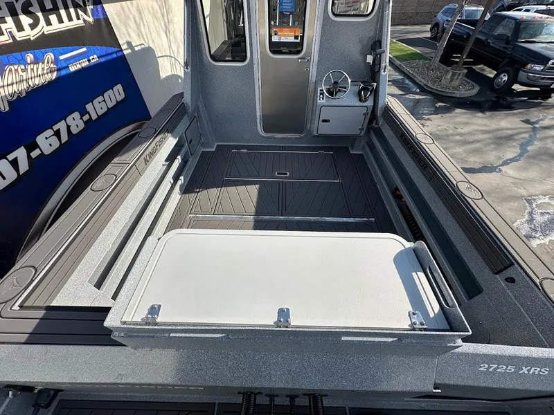 Slide: The Image of 2025 KingFisher 2725 XRS boat interior with open deck and steering console. - 14
