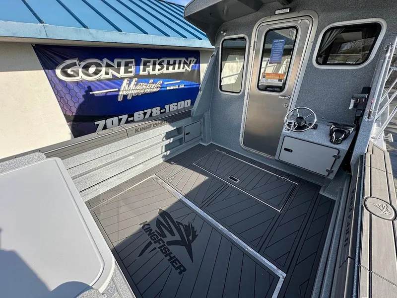 Slide: The Image of 2025 KingFisher 2725 XRS boat deck with fishing gear and "Gone Fishin" banner. - 17
