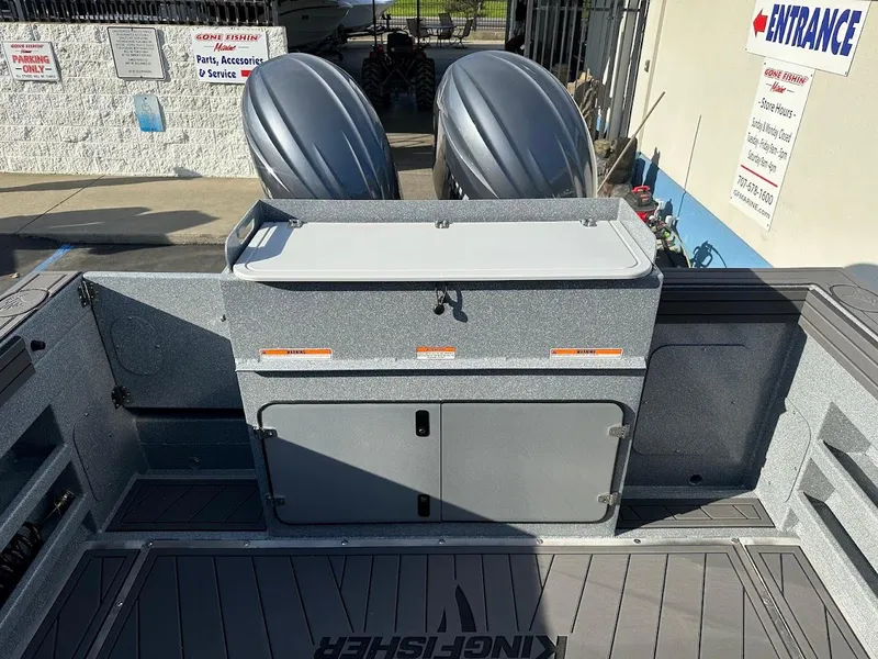 Slide: The Image of 2025 KingFisher 2725 XRS boat with dual outboard motors, docked at a marina. - 19
