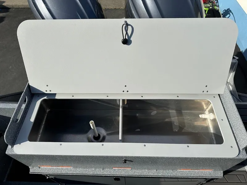 Slide: The Image of Open storage compartment on 2025 KingFisher 2725 XRS boat. - 22