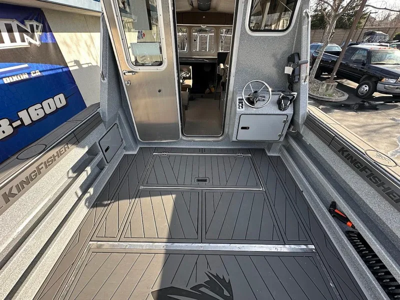 Slide: The Image of 2025 KingFisher 2725 XRS boat interior with spacious deck and modern controls. - 23