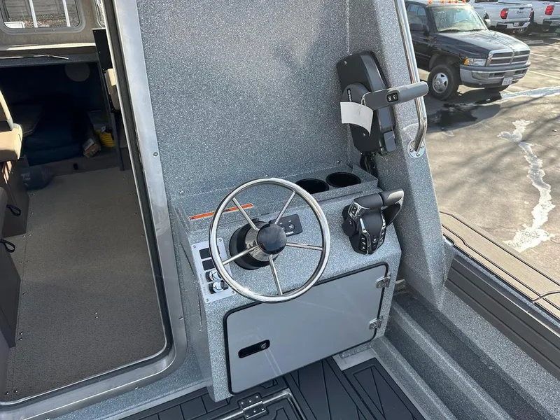 Slide: The Image of Interior view of 2025 KingFisher 2725 XRS boat cockpit with steering wheel and controls. - 25