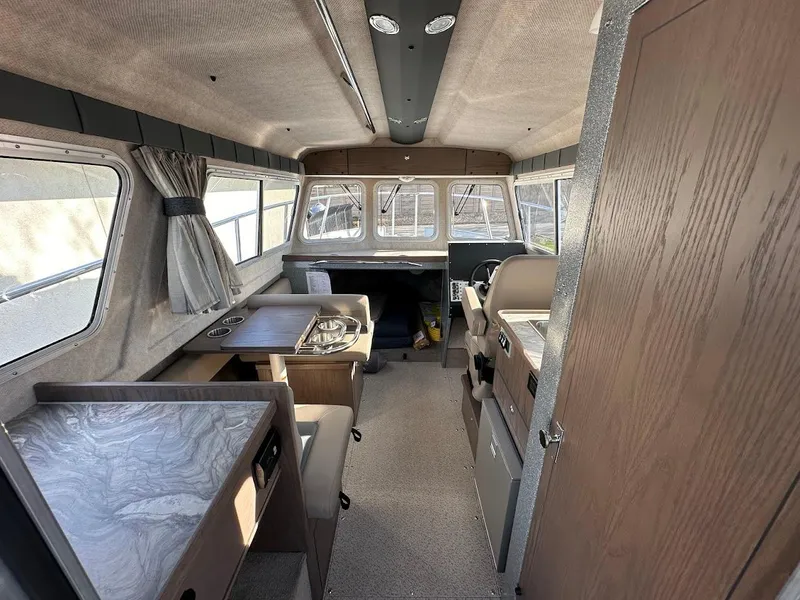 Slide: The Image of Interior of 2025 KingFisher 2725 XRS boat, featuring seating and navigation area. - 29