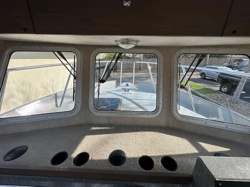 Slide: The Image of Interior view of 2025 KingFisher 2725 XRS boat cabin with windows and dashboard. - 34