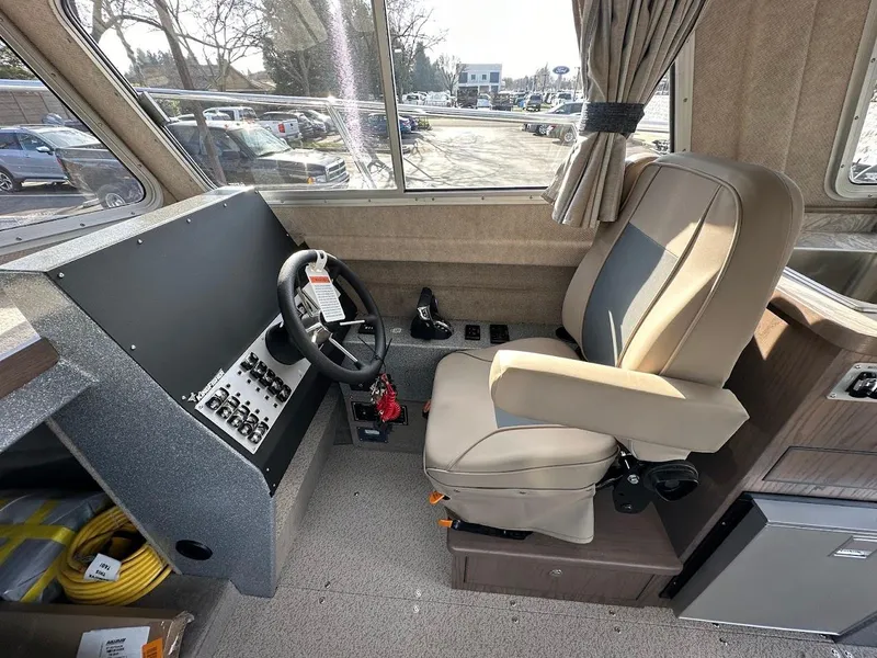 Slide: The Image of Interior of 2025 KingFisher 2725 XRS boat with steering console and captain's chair. - 36