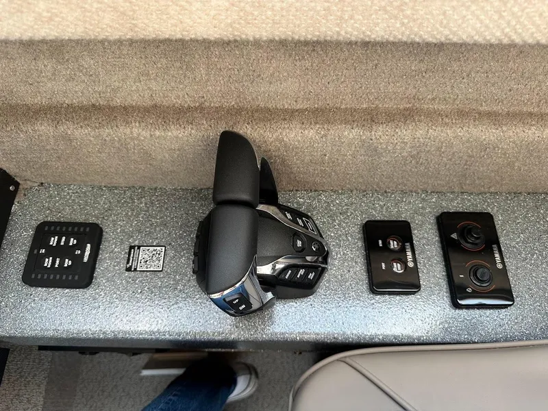 Slide: The Image of Control panel of 2025 KingFisher 2725 XRS boat with modern throttle and switches. - 39