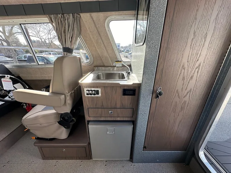 Slide: The Image of Interior of 2025 KingFisher 2725 XRS boat with sink, seat, and storage. - 40