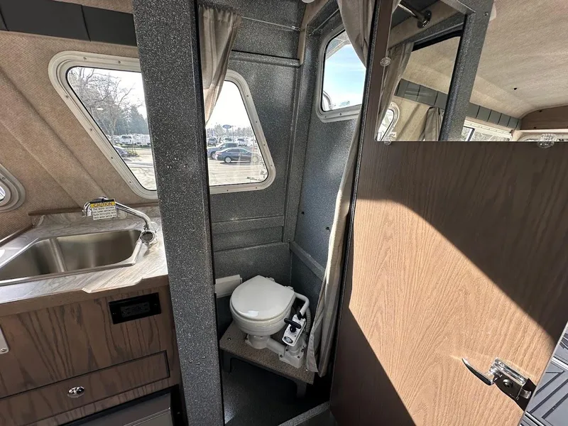 Slide: The Image of Interior of 2025 KingFisher 2725 XRS boat with compact bathroom and sink. - 47