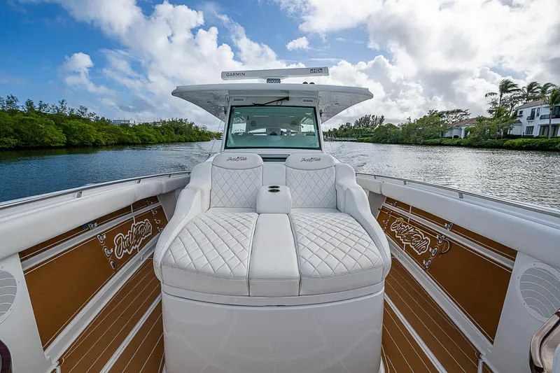 Slide: The Image of 2022 HCB 53 boat with luxurious seating on a scenic waterway. - 1