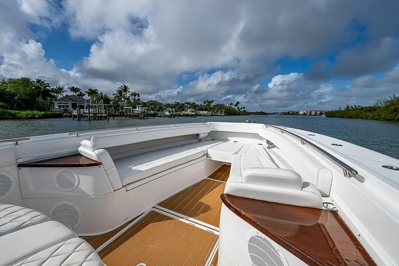 Slide: The Image of Luxurious 2022 HCB 53 boat with spacious seating, cruising on a scenic waterway. - 3