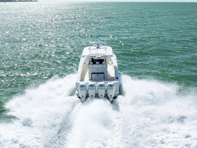 Slide: The Image of 2022 SeaVee 390Z boat speeding on open water, rear view. - 1