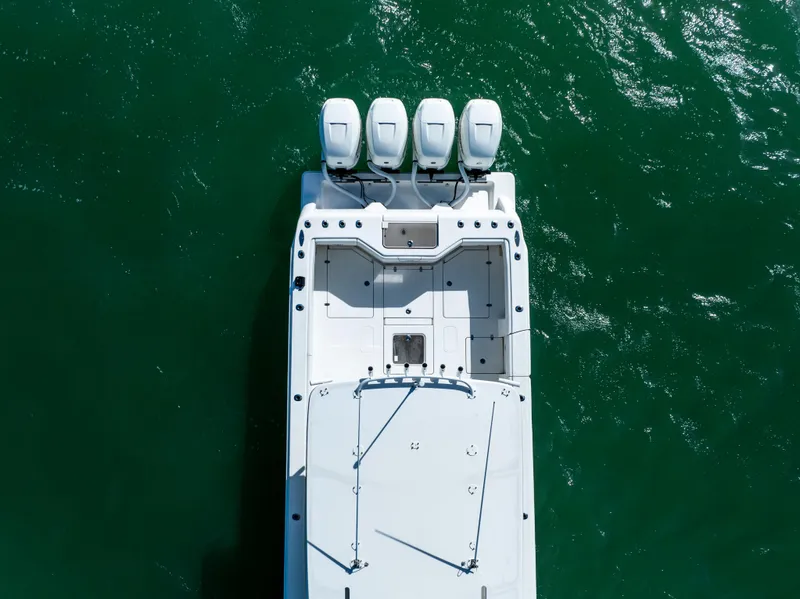 Slide: The Image of Aerial view of 2022 SeaVee 390Z boat with four engines on green water. - 10