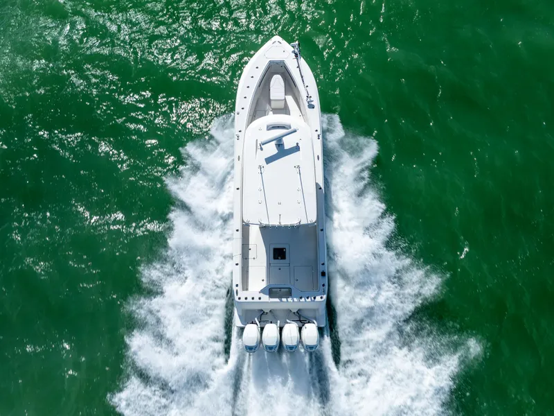 Slide: The Image of Aerial view of 2022 SeaVee 390Z boat cruising on green water. - 2