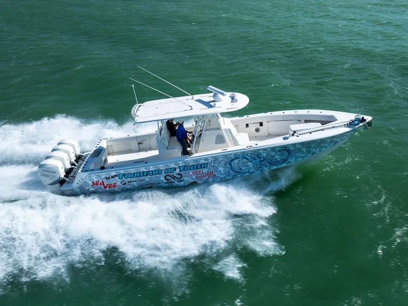 Slide: The Image of 2022 SeaVee 390Z boat speeding on open water, featuring vibrant graphics and triple outboard engines. - 5