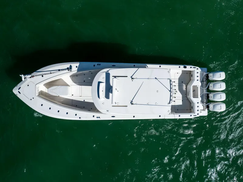 Slide: The Image of Aerial view of 2022 SeaVee 390Z boat with four engines on green water. - 8